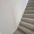 view of the stairs with a gray carpet 