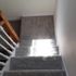 gray carpet on the stairs in the house 