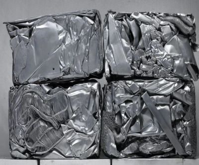 Four compressed blocks of metal scrap.