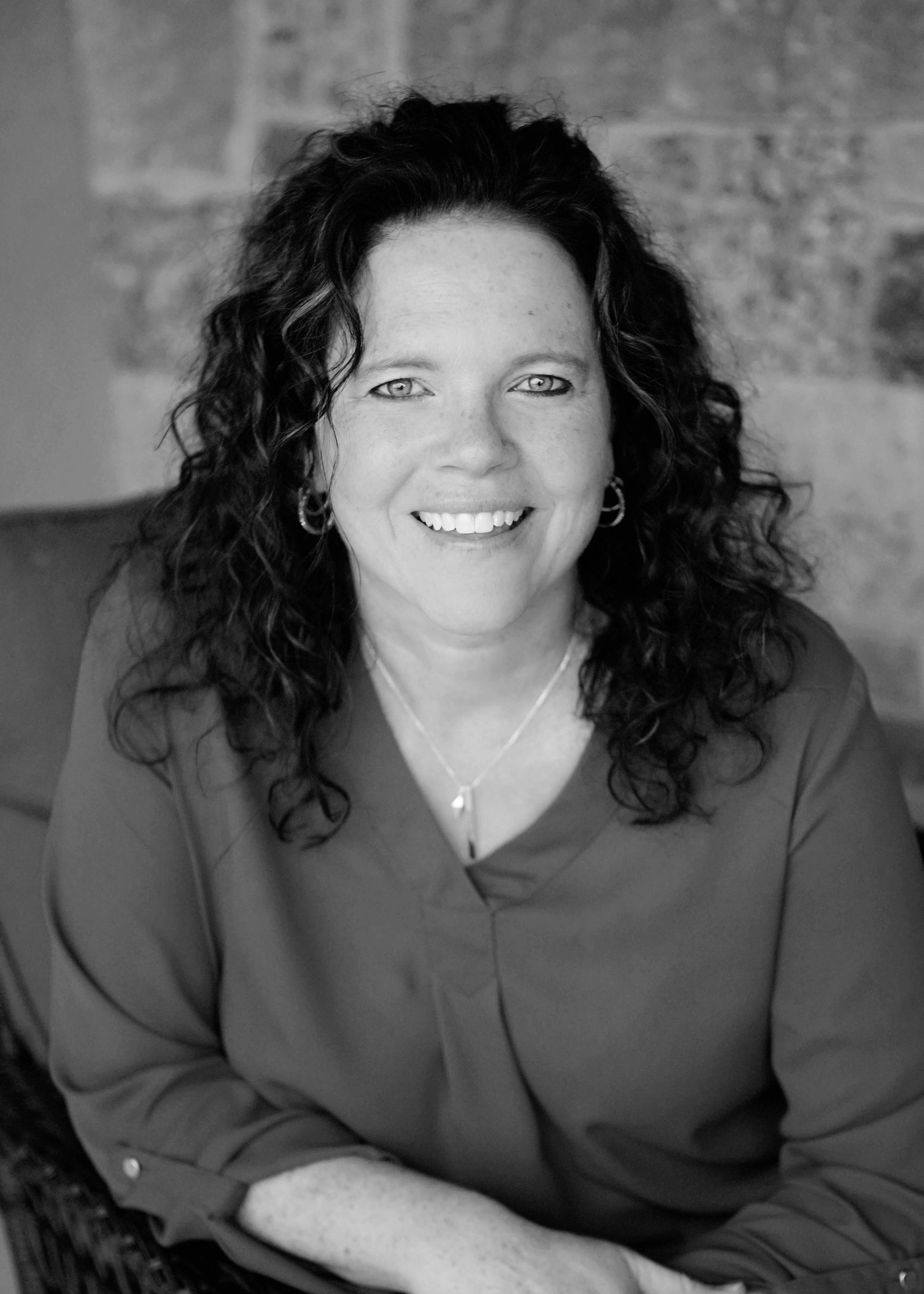 Dr. Mary Kauffman, keynote speaker and mental toughness expert, smiling in black-and-white professional portrait.