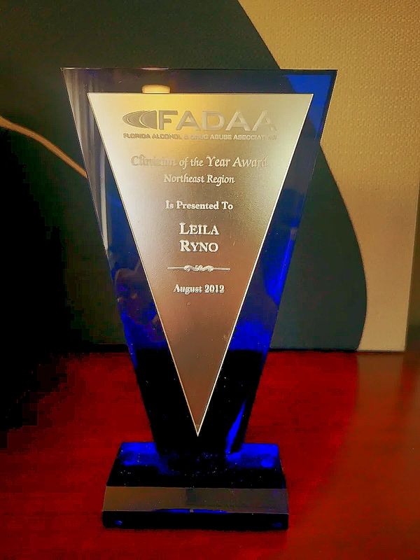 Blue and silver award trophy presented to Leila Ryno in 2012.