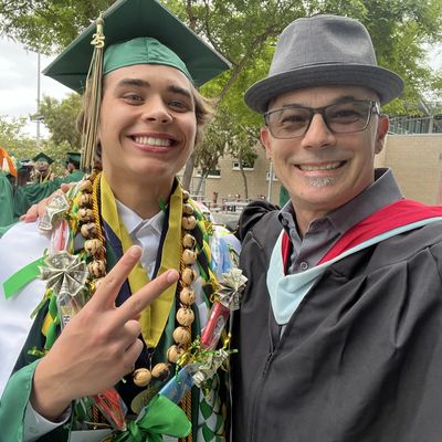 Happy graduate and proud mentor posing after graduation ceremony.