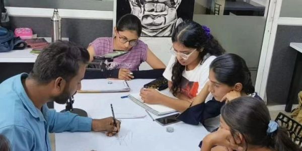 A group of people focused on drawing and sketching at a table.