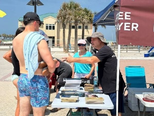 People receiving ministry at the Pensacola Family Beach Fest 2025 prayer tent