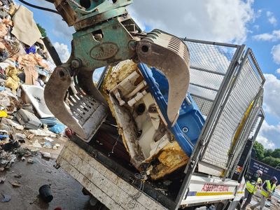 A scenic landscape featuring mountains, a lake, and a clear blue sky.