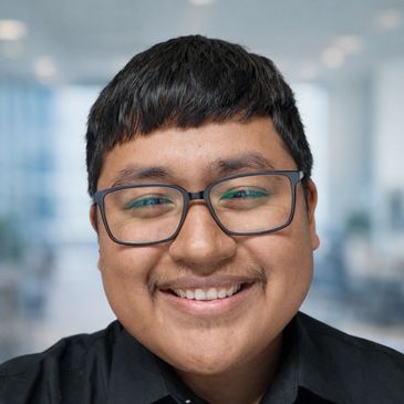 Smiling young man wearing glasses and black shirt.