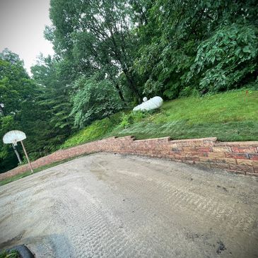 Retaining wall for hillside retention along private drive. 