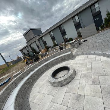 Half moon seating wall with fire pit to entertain guests 