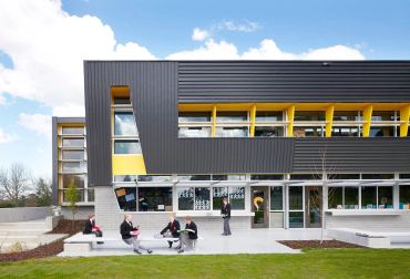 Modern building with students outside.