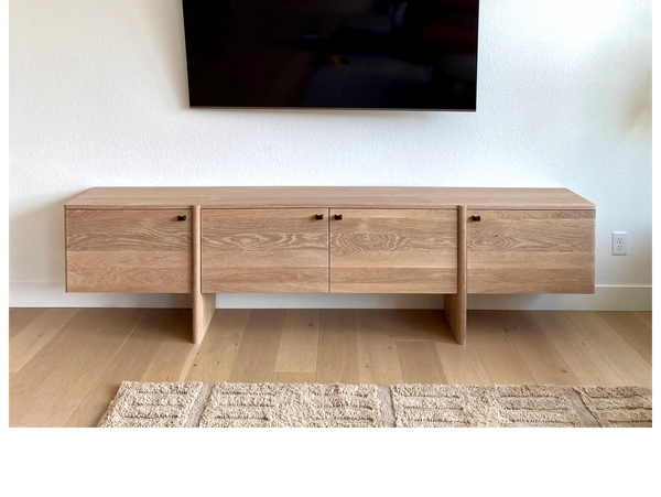 Modern floating wooden TV console with clean lines and natural finish.