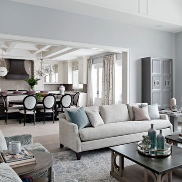 Modern open-concept living and dining area with neutral tones and elegant decor.
