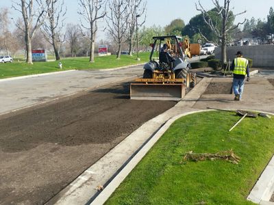 Asphalt removal and replacement for a damaged area within parking lot.