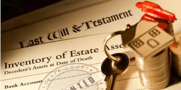 A last will document with keys and house keychain on coins.