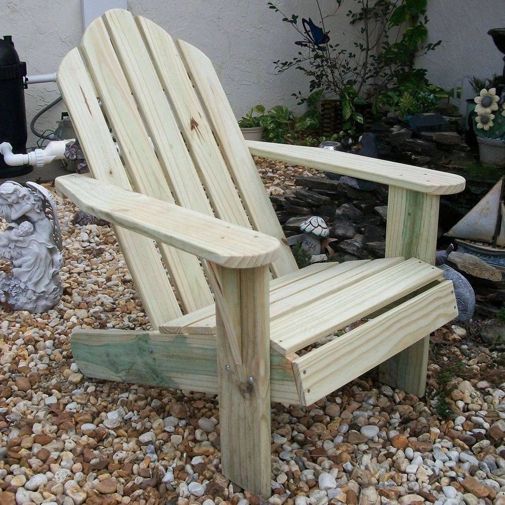 Two white Adirondack chairs with patriotic heart pillows and American flags.
