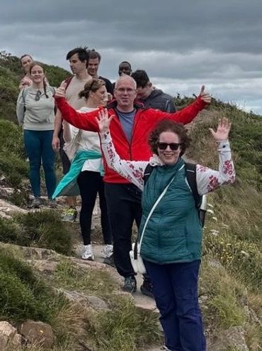 Group hiking outdoors on a cloudy day.