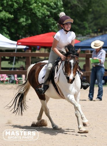 Young girl riding a horse during a competition.