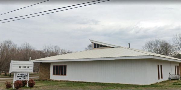 Exterior of a worship center building on a cloudy day.