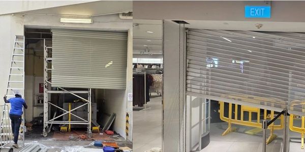 Partially closed metal rolling shutters in two different indoor areas under maintenance.