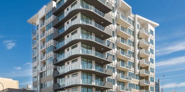Modern multi-story residential building with balconies.