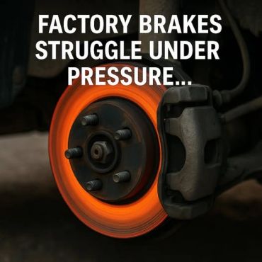 A car's brake rotor glowing red-hot under extreme pressure.