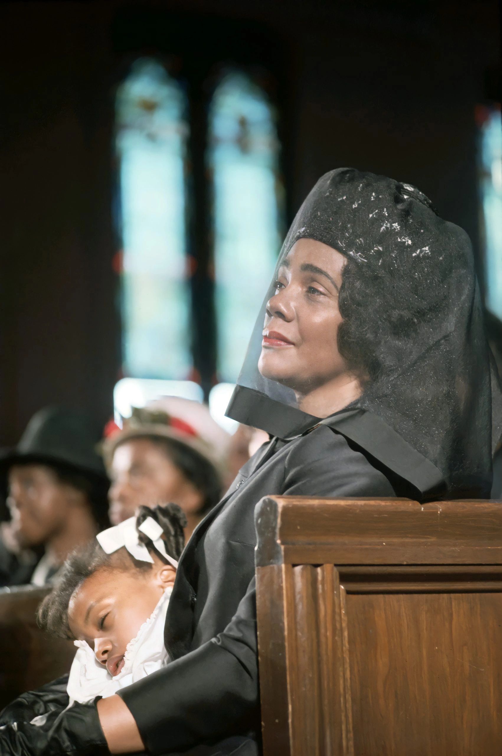 New widow Coretta Scott King, seated in pew, 1968, with daughter on lap. Photo, Moneeta Sleet Jr.