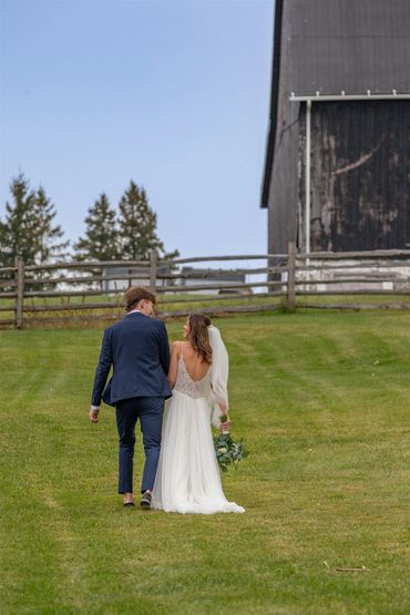 bride, groom and barn