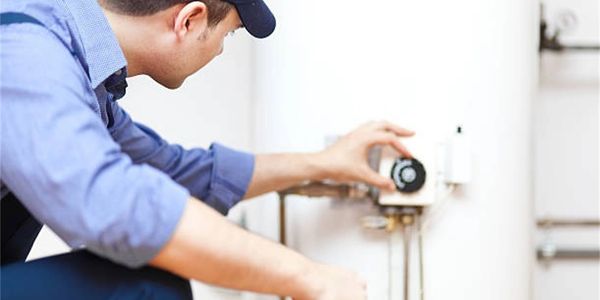 Plumber checking a water heater for a repair