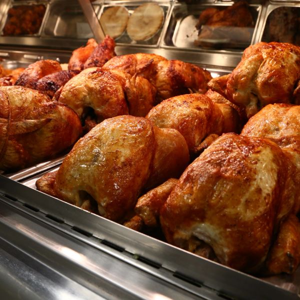 Rows of roasted whole chickens on display.