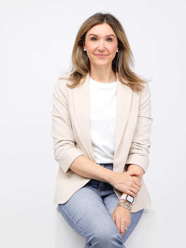 CEO and Author Jamie Moraga in business casual attire against a plain background.