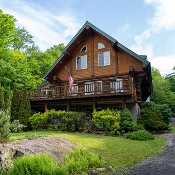 Photo of a log cabin from the ground