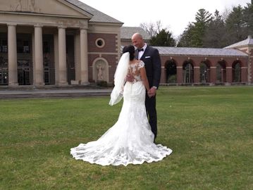 Photo of a bride and groom looking at each other in a large courtyard