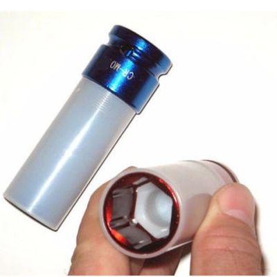 A hand holding a blue and white socket wrench adapter.