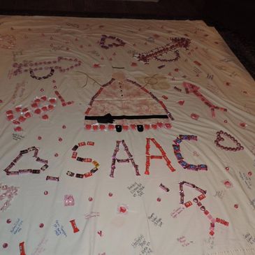 Quilt with candy spelling out a name and messages.