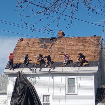 6 Roof Inc. Roofer's stripping an old roof.