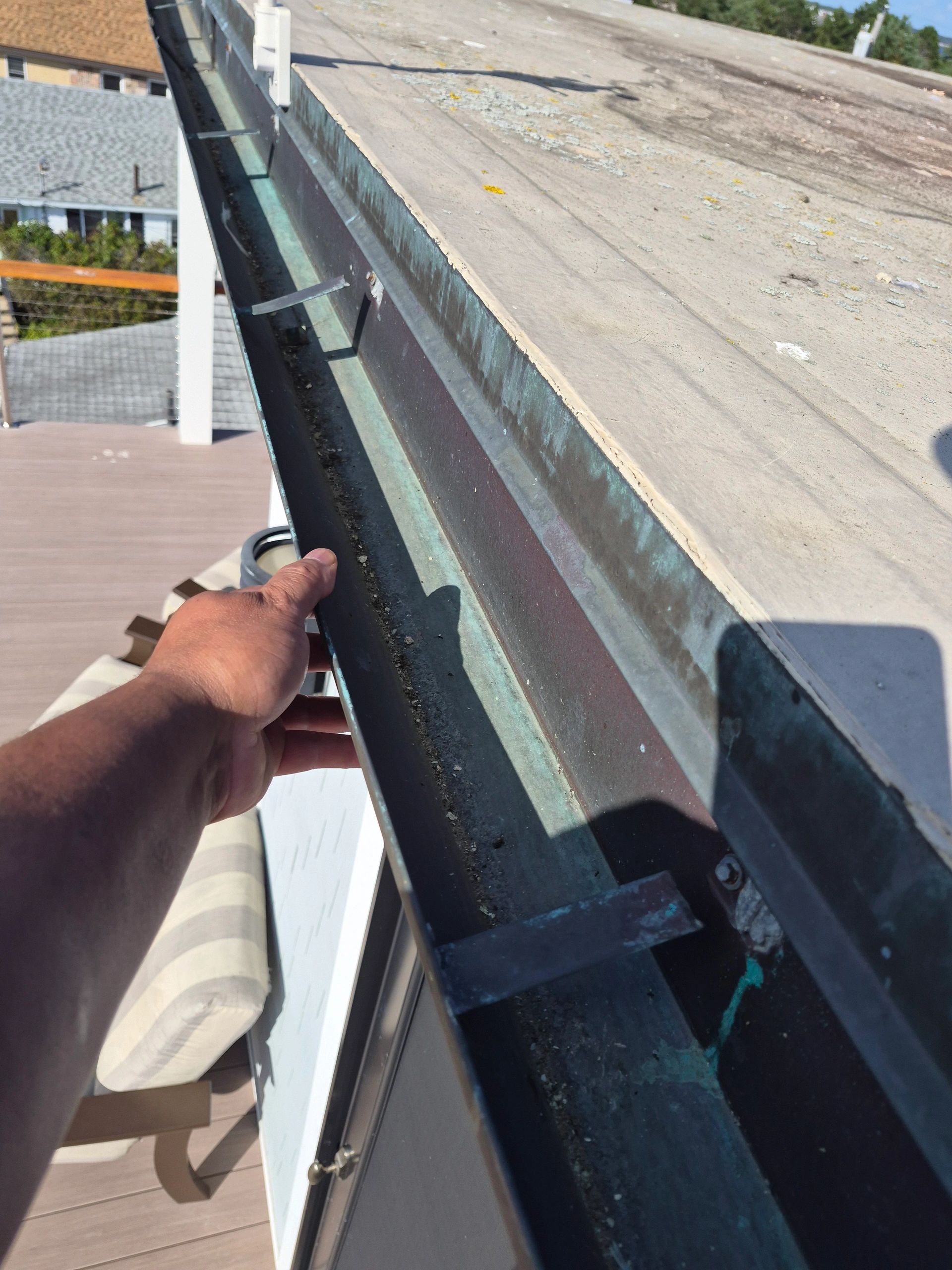 Close-up of a gutter edge showing wear and debris in Biddeford, ME