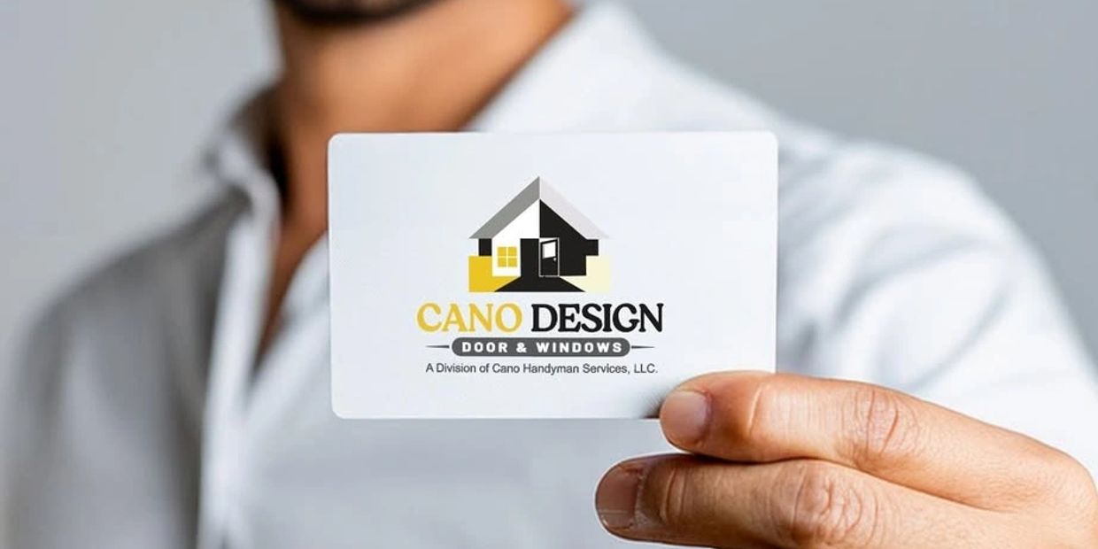 Person holding a Cano Design door and windows business card.
