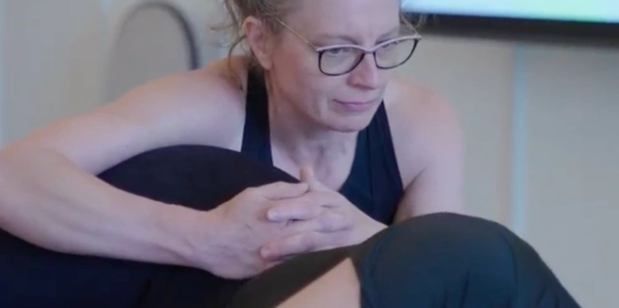 A therapist using fascia stretch to alleviate low back pain. 