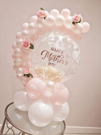Mothers day hug balloon sat on a table in pink and white 
