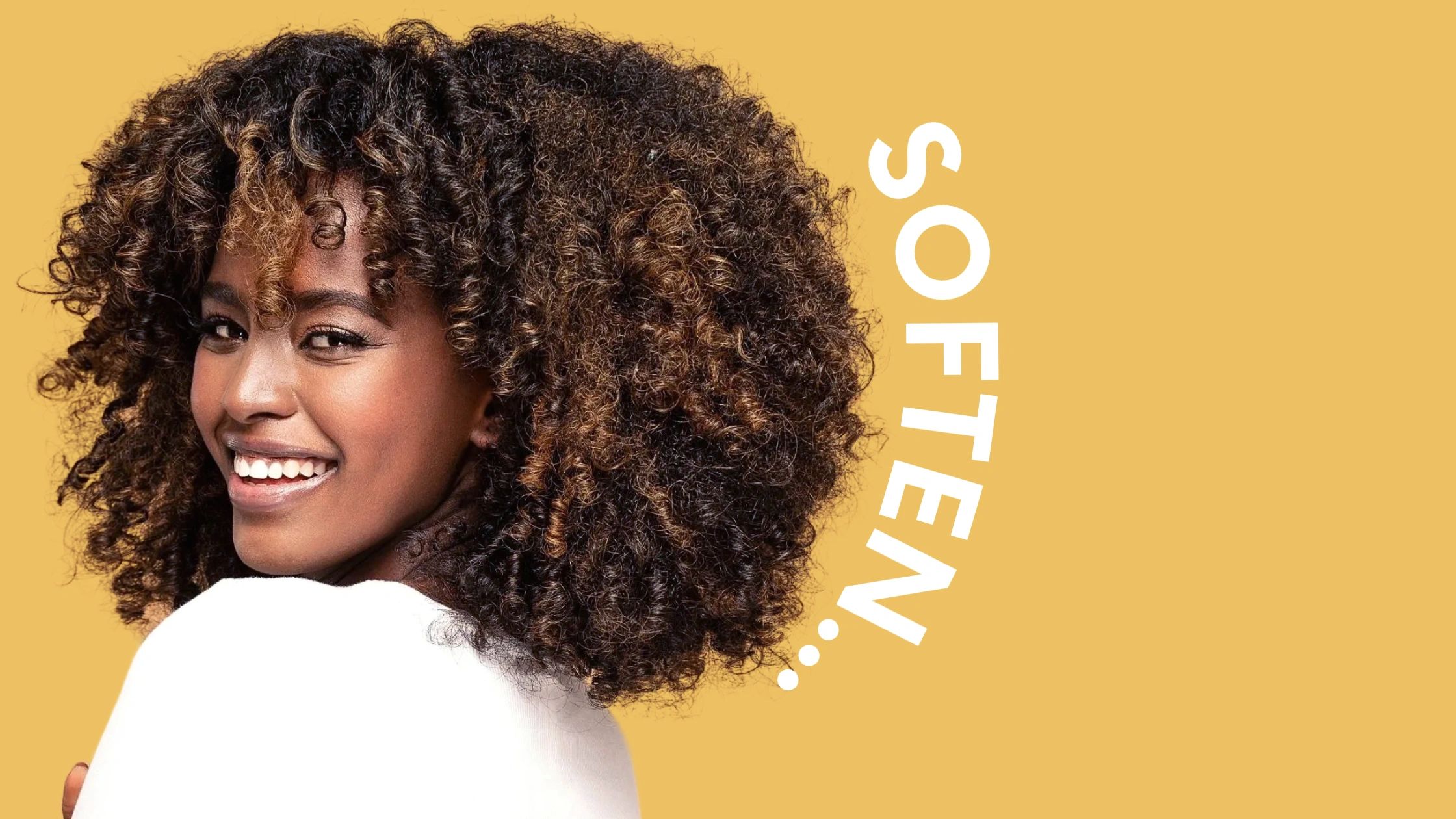 Image of woman with curly hair smiling 