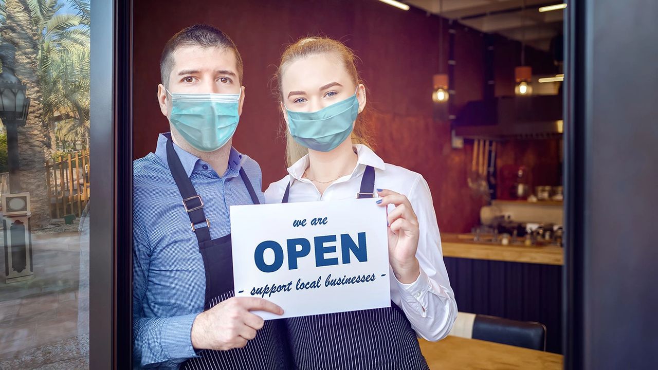 masked couple opening business