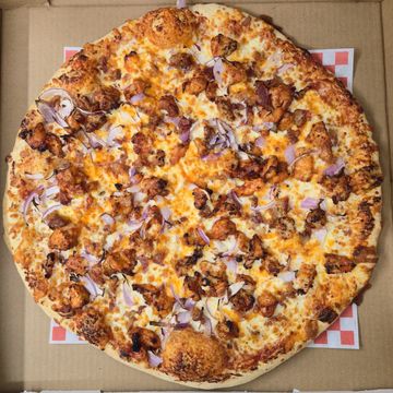 Smoky BBQ chicken pizza with red onions, bacon, and cheddar. Fast delivery, Sargent Ave, Winnipeg.