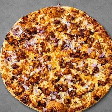 Smoky BBQ chicken pizza with red onions, bacon, and cheddar. Fast delivery, Sargent Ave, Winnipeg.