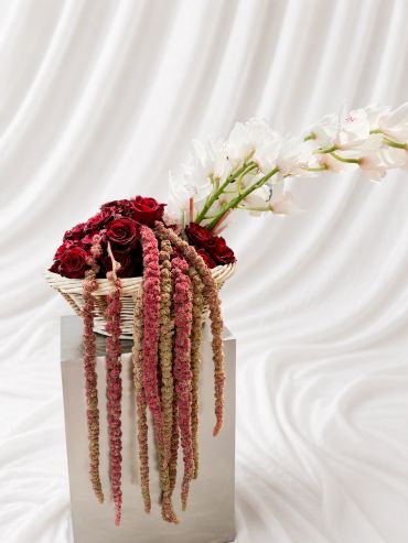 Elegant floral arrangement with red roses and white flowers.