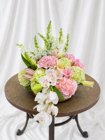 Elegant pastel floral arrangement on a round table.