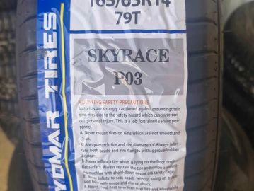 Close-up of a Skyrace tire label with specifications and safety precautions.
