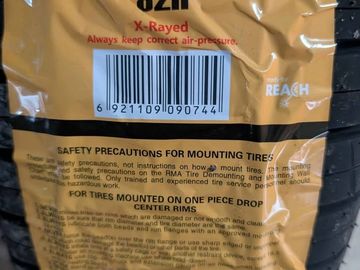 Close-up of tire packaging with barcode and safety instructions.