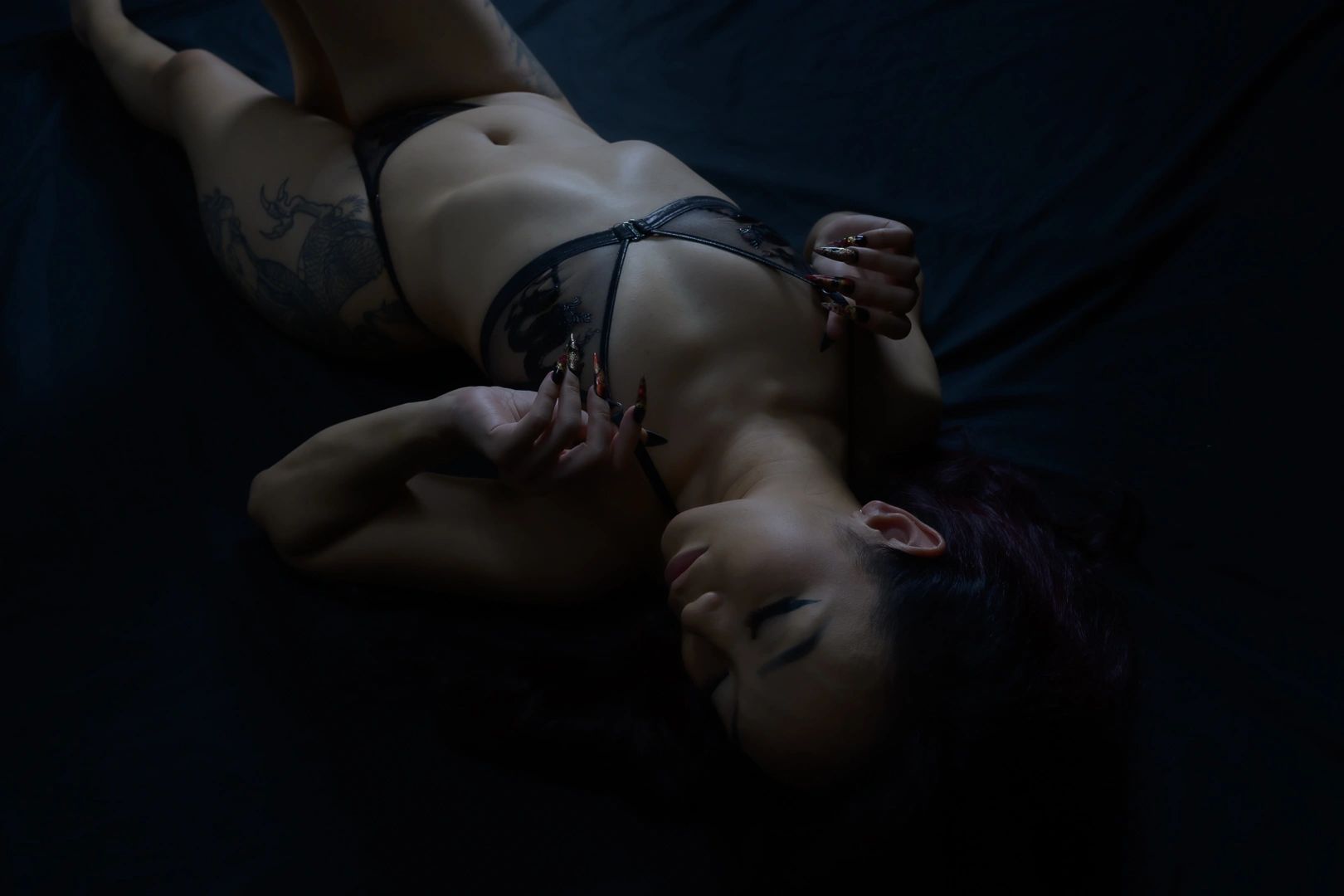 woman on black material in lingerie