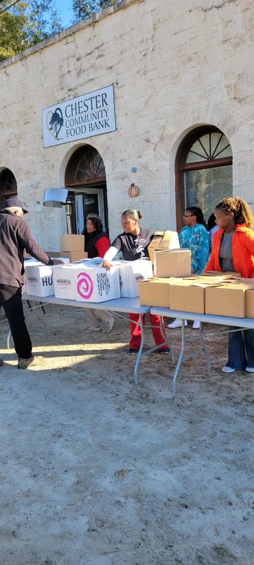 People distributing food boxes outside Chester Community Food Bank.