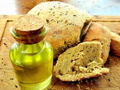 White bread loaf made with wheat, dandelion oil, pink salt, dried parsley leaves, and water. Glazed 