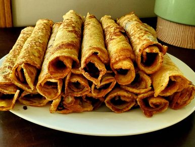 Crapes made with wheat, water, and fresh farm eggs. Filled with blue plums and raw honey! Fried in d